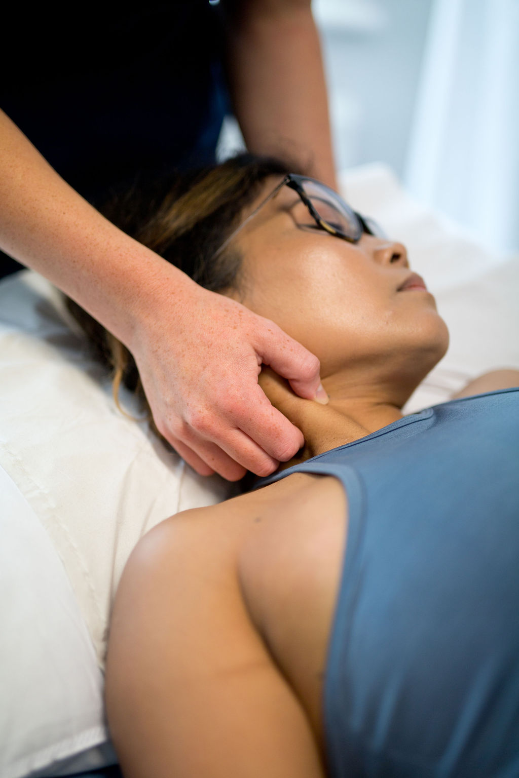 Sports therapist providing hands-on neck treatment at SoCo Therapies