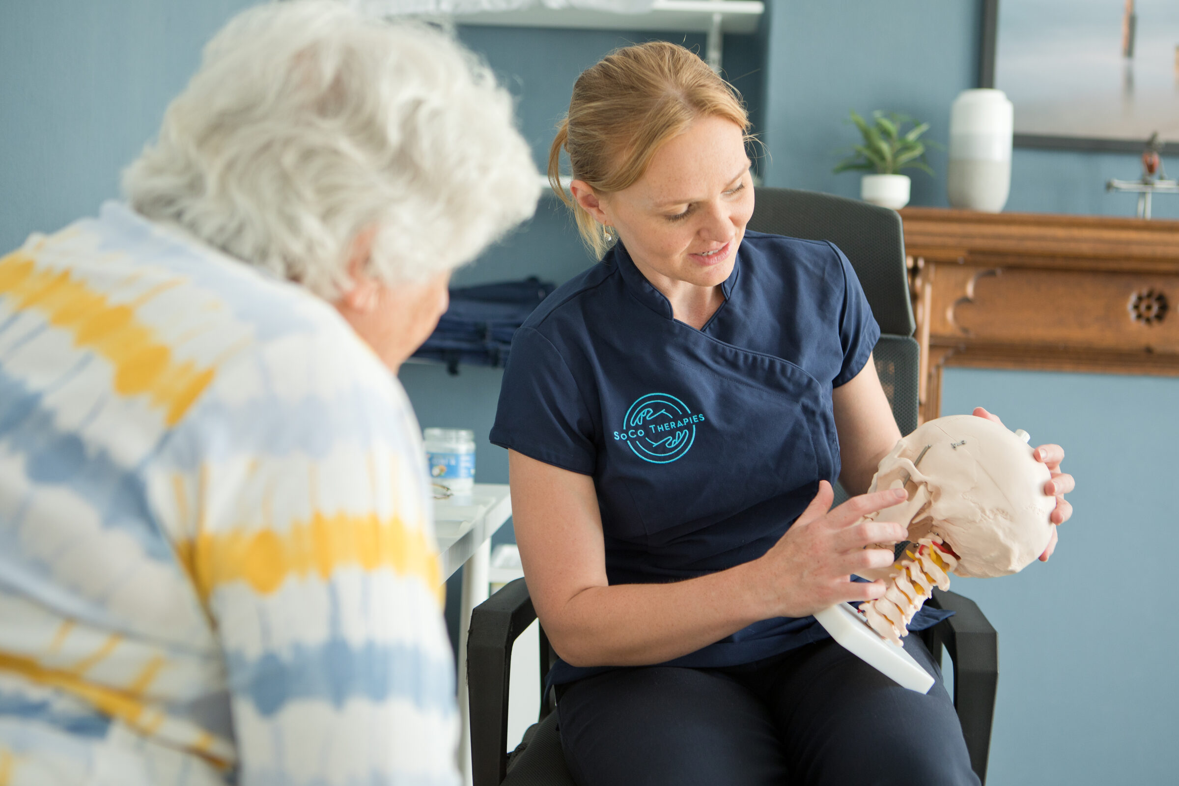 SoCo Therapies practitioner explaining treatment to a patient