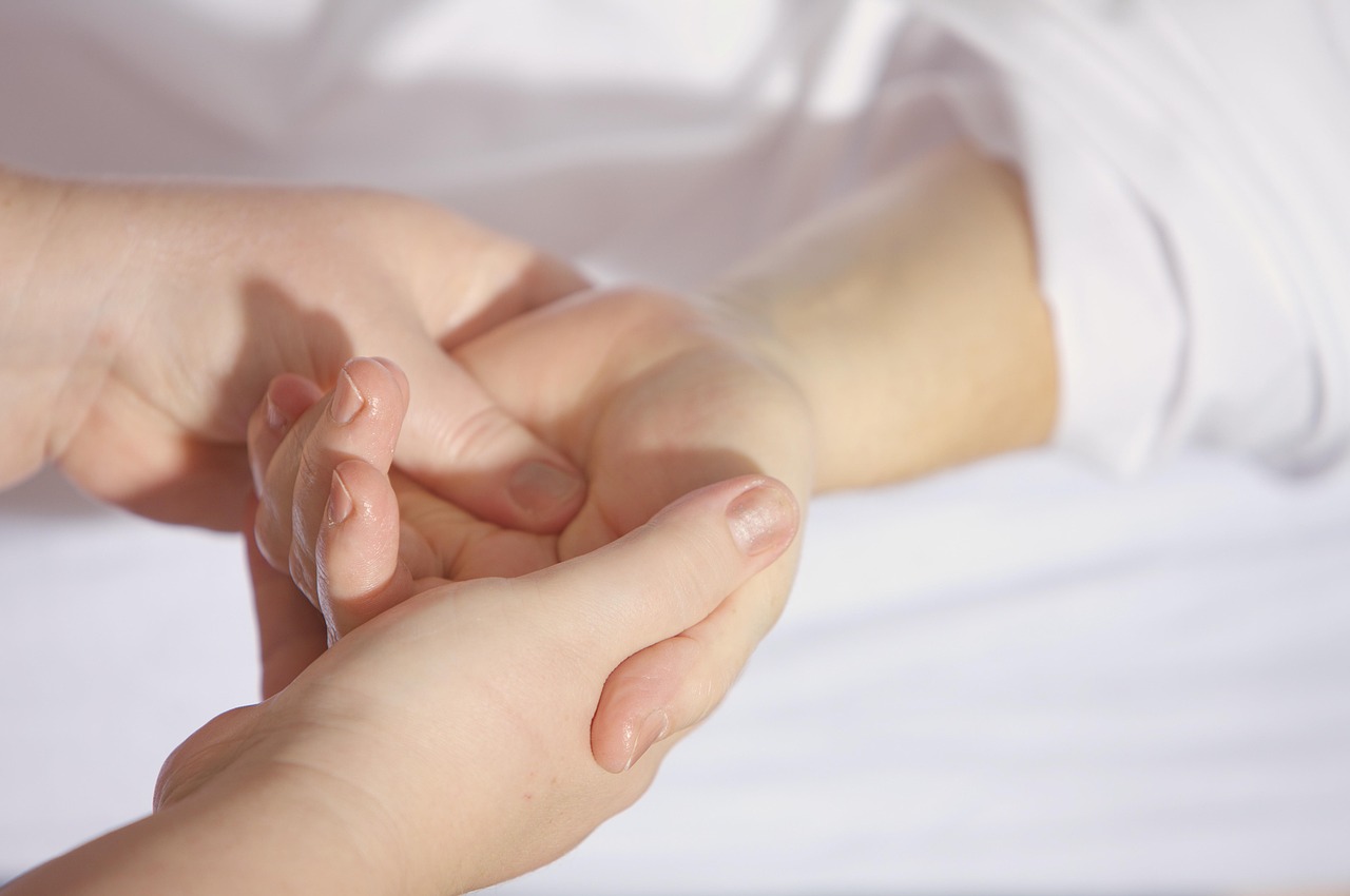 Hands providing gentle therapeutic care